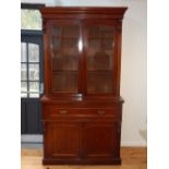 A Victorian mahogany secretaire bookcase the glazed upper section over a leather lined maple faced