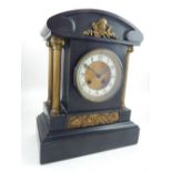 A late 19th century French black slate mantel clock, eight day drum movement, chimes on the half