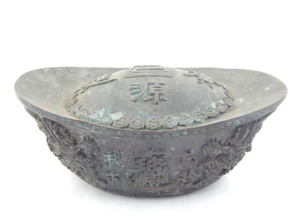 A Chinese bronze and copper ornament, character marks to top the elliptical body adorned with