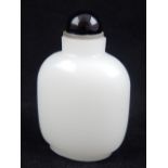 A Chinese white jade snuff bottle, with black stopper. H. 8.5cm