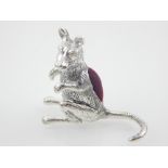 A white metal pin cushion, fashioned as kangaroo.