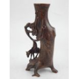 A Chinese bronze brush holder, modelled as a prunus stump with an immortal on a mule. H. 15.5cm