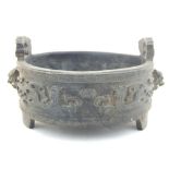 A Chinese bronze dish, twin-lug handles, dragons around edge separated by temple dog masks, set on