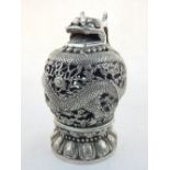 A Chinese white metal incense burner, the cover modelled as a dragon, raised on a lotus base,