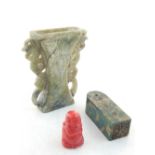 A Chinese carved red coral figure of a plump Buddha, together with a jade pedestal seal, and a