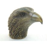 A Chinese brass eagle's head, bears seal mark to base. H. 14cm