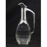 A German silver mounted engraved glass liqueur decanter.