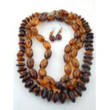 Two amber beaded necklaces, together with a pair of white metal amber drop earrings,