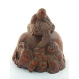 A Chinese bamboo carving of children giving an ox water. H. 10cm