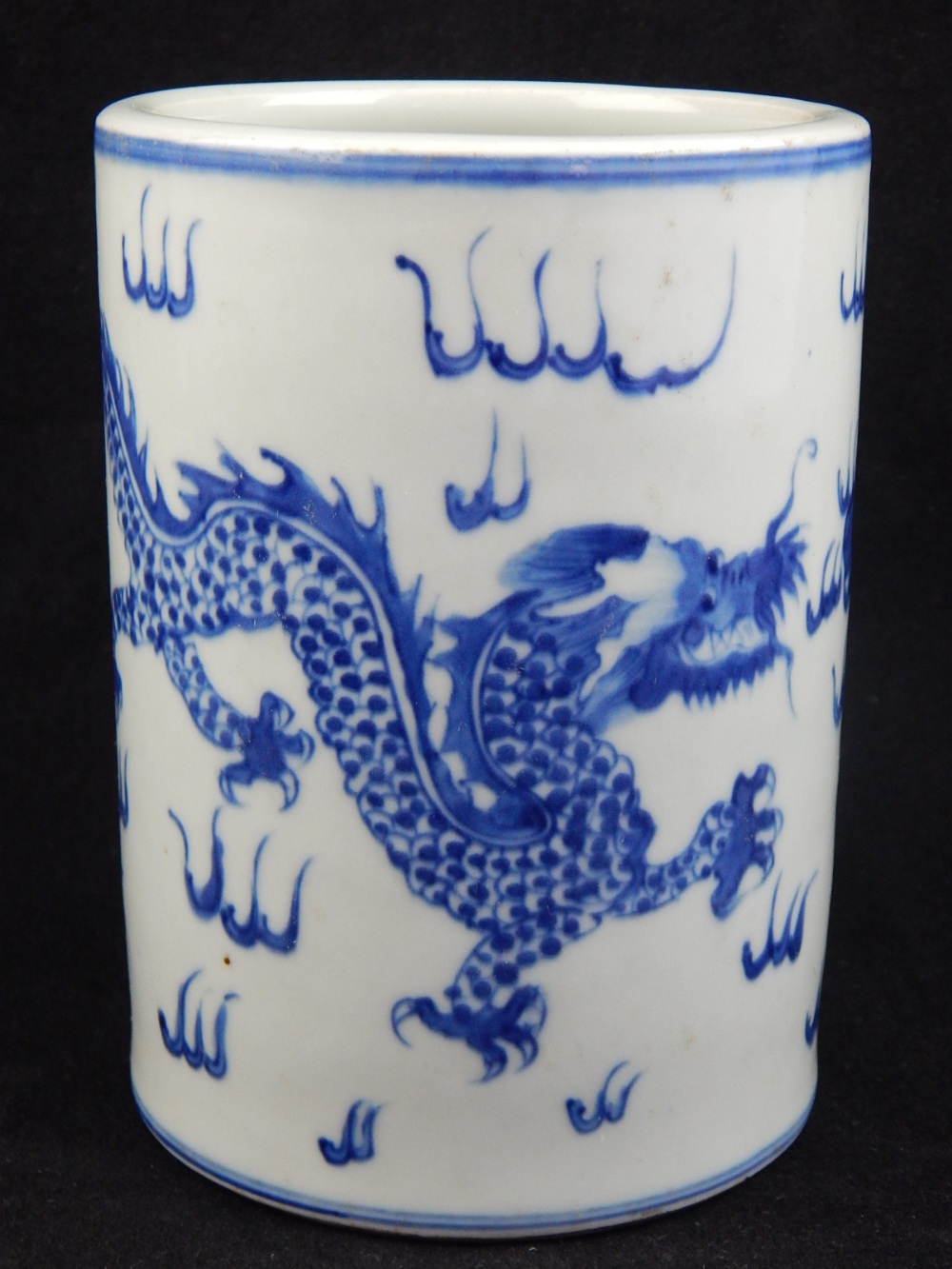 A 20th century Chinese brush pot, blue glaze decoration of dragons and flaming pearl. H. 13.5cm