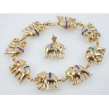 An 18ct yellow gold and diamond bracelet, the links cast as elephants, set rubies, sapphires or