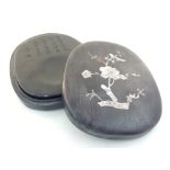 A Chinese inkstone, contained within a mother-of-pearl inlaid hardwood case, decorated with a bird