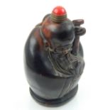 A Chinese horn snuff bottle carved in the form of sage, red jade stopper. H. 7.5cm