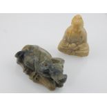 Two Chinese jade carvings, to include a study of a seated Buddha holding an orb, H. 6cm, and a prone