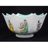 A Chinese fluted bowl, with sea green interior, decorated with studies of the eight immortals to