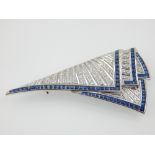 An Art Deco style 18ct white gold, channel set diamond and sapphire brooch.