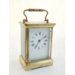 A French brass carriage clock, oval aperture, four glass, brass grade mechanism, possibly