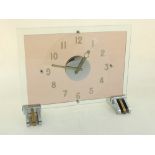 An Art Deco amethyst and clear glass mounted clock, 15 jewel movement and registered design