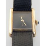 A Must De Cartier ladies silver gilt wristwatch, circa 1980, with rectangular black dial, fitted