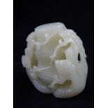 A Chinese jade paperweight, carved as a tree trunk with blossoming flowers. H. 7cm