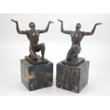 A pair of contemporary bronze studies of a nude man in kneeling pose lifting his arms to God, on