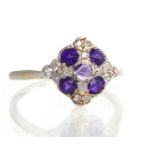 An 18ct white gold, amethyst and diamond lozenge shape ring, claw set circular faceted stones.