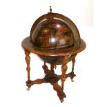 A reproduction terrestrial globe, on turned baluster stand. H. 100cm