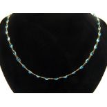 A 14ct yellow gold blue topaz single strand necklace, with open links set oval faceted stones.