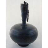 An Indian pewter flask form bottle, with bronze inlay and chained cup.