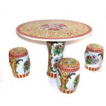 A Chinese circular ceramic table, together with three matching barrel stools. (4)