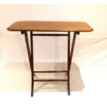 A late Victorian walnut folding coaching table, on splayed legs with turned stretchers. W. 74cm