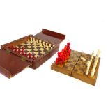 An early 20th century mahogany cased travelling chess set, together with a similar later set with