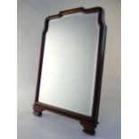 An early 20th century mahogany strut mirror, shaped trim, bevel glass. 47 x 33.5cm