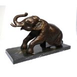 A contemporary patinated bronze of a seated elephant, on rectangular marble plinth. L. 34cm