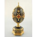 House of Faberge, the Imperial jeweled egg chess set, black and gilded brass egg with Russian double