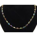 A 14ct yellow gold multi-gem stone necklace, to include tourmaline, garnet, topaz and others.