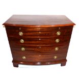 A mid 20th century bow front chest of drawers, bachelor's chest with brushing slide over four