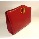 Dunhill, a ladies red evening clutch bag, with matching vanity mirror in stitched leather. 22.5cm (