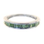 A 9ct white gold and green tourmaline half eternity ring, channel set baguette cut stones.