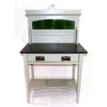 An Art Nouveau washstand, green tile splash back, black marble top, single drawer with whiplash