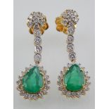 A pair of 18ct yellow gold, emerald and diamond drop earrings.