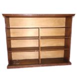 A 1920s oak four tier open bookcase, with later divisions. W. 140cm