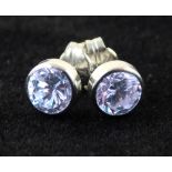 A pair of 9ct white gold white stone solitaire ear studs.