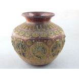 An Indian copper and brass ghee pot of compressed globular form, and elaborate panels depicting