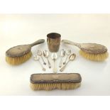 An early 20th century silver ladies dressing table set, to include three brooches, various