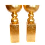 A pair of contemporary gilt composition urns, on ball stems and square plinth bases. H.