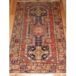 Kazak rug, the centre with red and blue square medallions within medallions,
