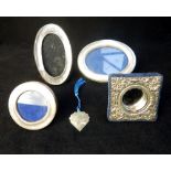 Four silver photograph frames, including floral embossed, 6.3 x 6.3cm, and a silver bookmark.