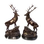 After Moigneaux a pair of bronze stags modelled standing on rocky outcrops,