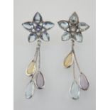 A pair of white gold flower shape earrings set with aquamarine, citrine and amethyst.